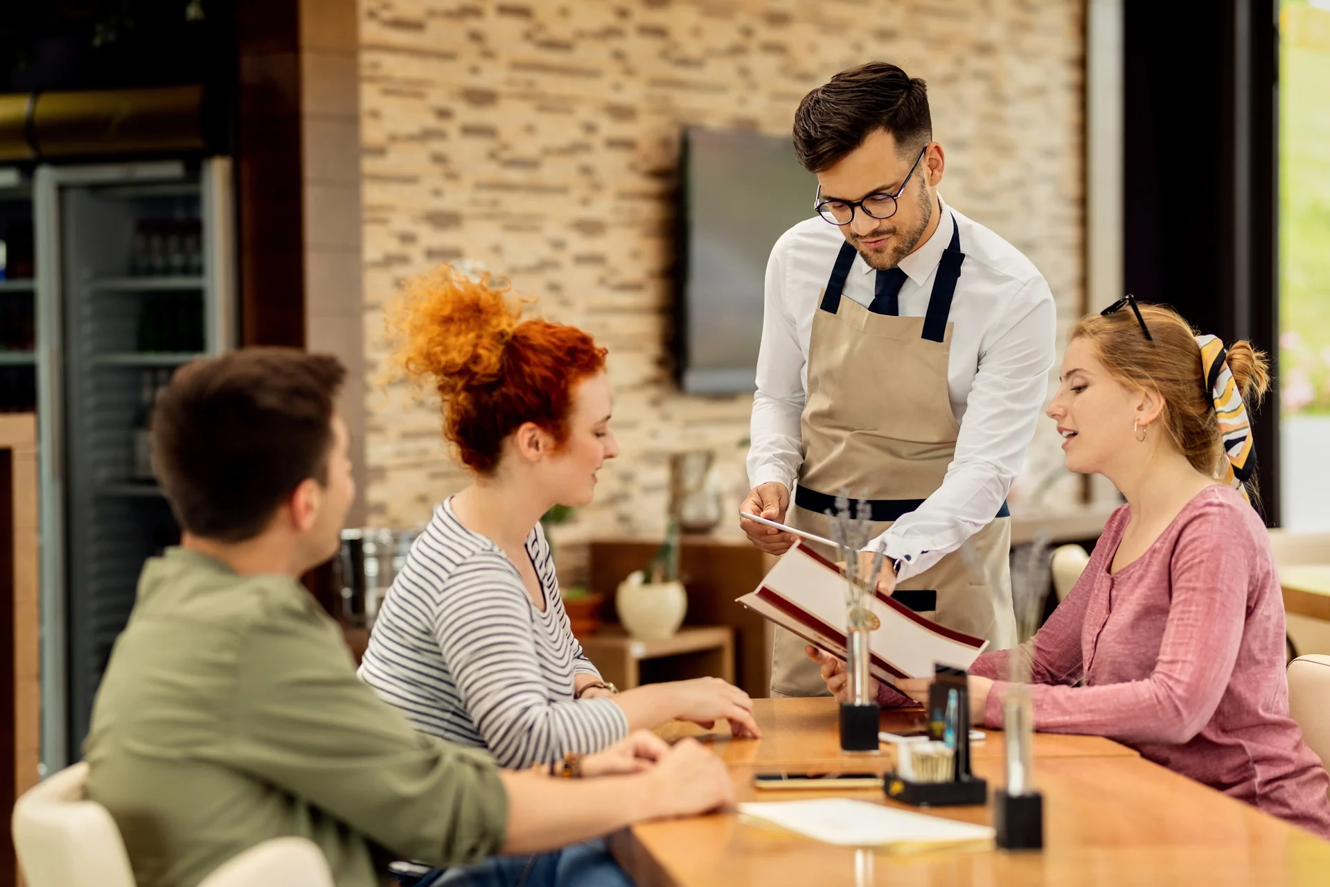 Server using a handheld POS at the table