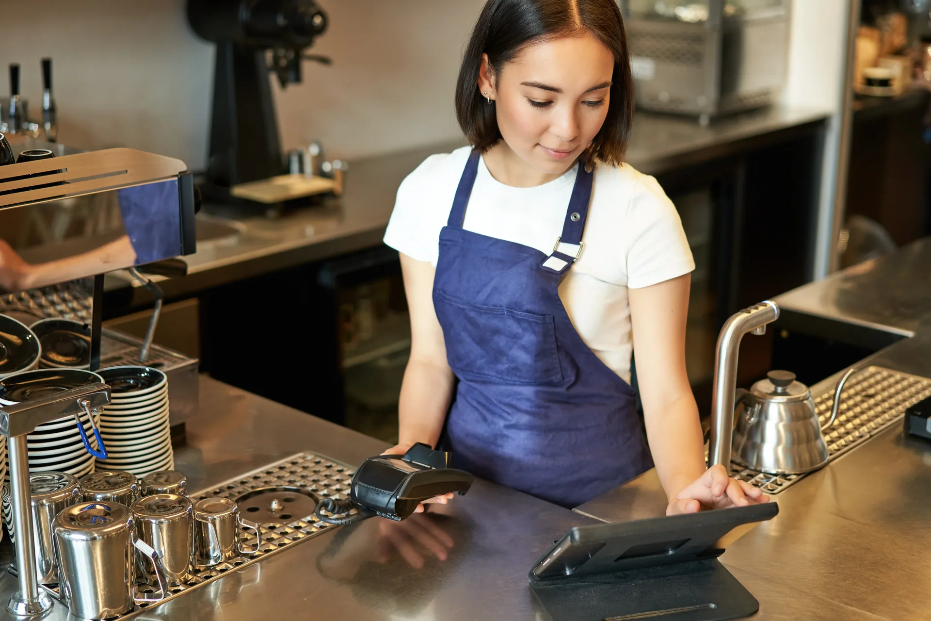 Modern Chinese restaurant chain cashier counter with POS touchscreen terminal